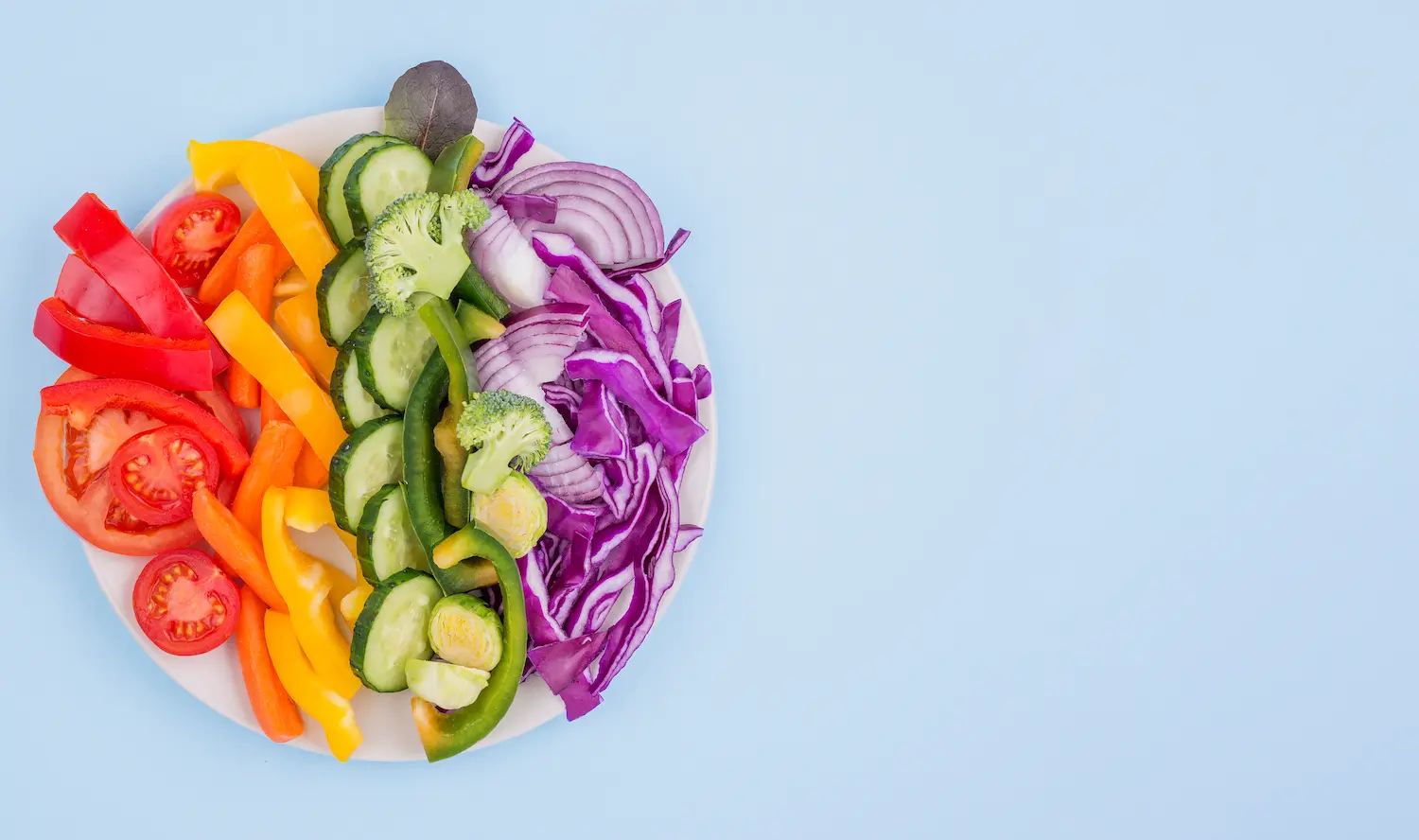A divided container with colorful raw veggies laid out neatly